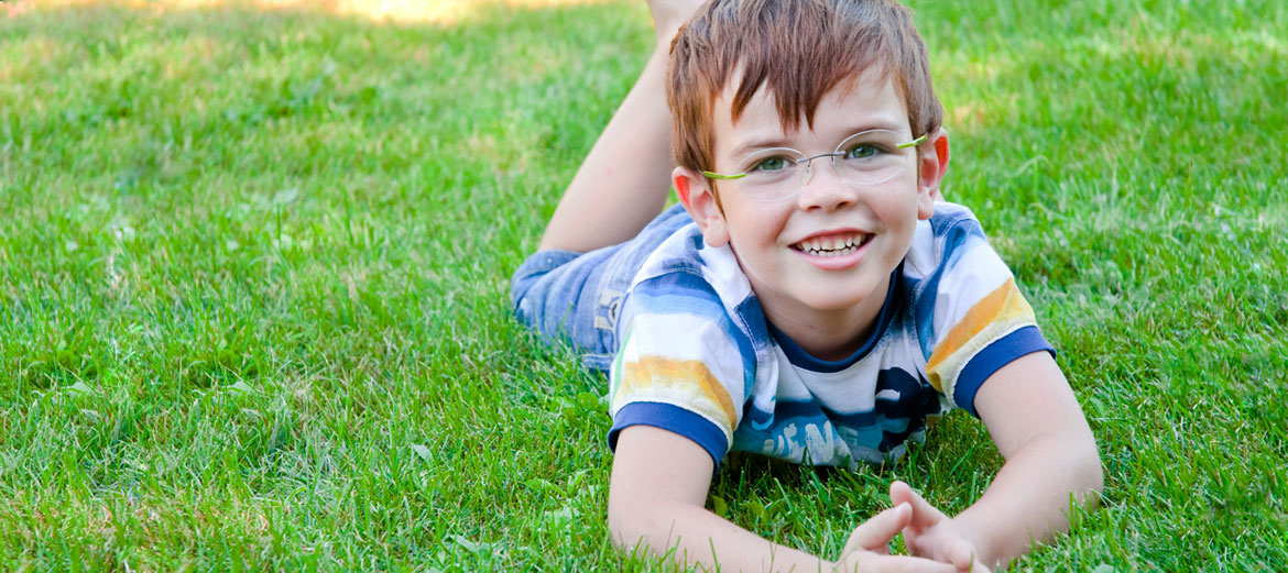 child outside wearing glasses